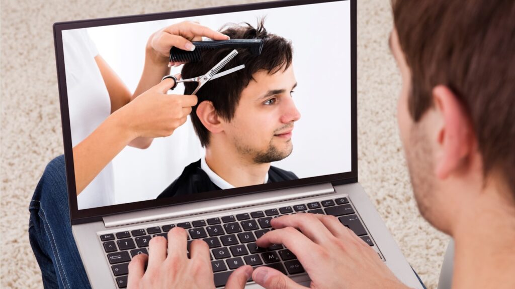 Person watching barbering on laptop