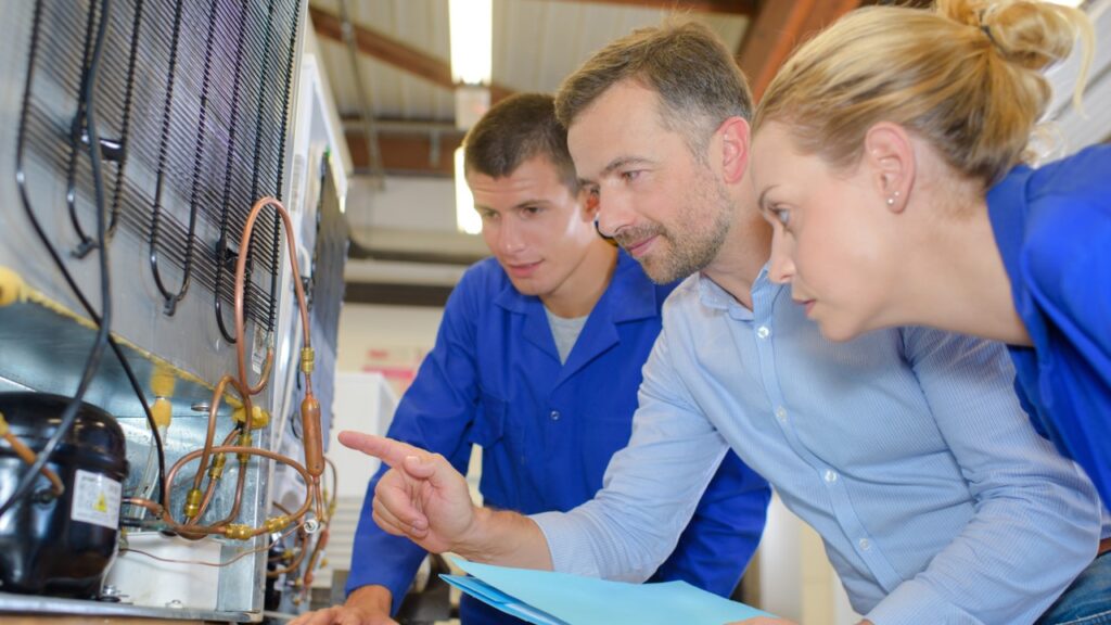 People looking at refrigeration system